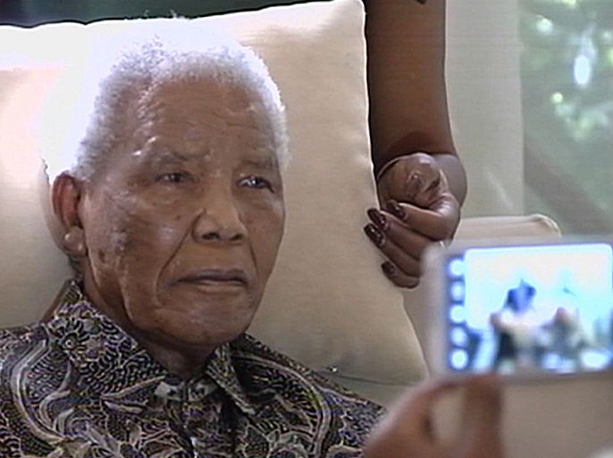 A picture released by South African broadcaster SABC shows South African peace icon Nelson Mandela sitting at his home in Johannesburg, on April 29, 2013. The 94-year-old appeared slightly gaunt and showed little expression in brief images captured. They were the first public images of Mandela since then US secretary of state Hilary Clinton visited in August. AFP PHOTO / SABC = DO NOT USE AFTER MAY 1, 2013 5.30PM GMT = RESTRICTED TO EDITORIAL USE