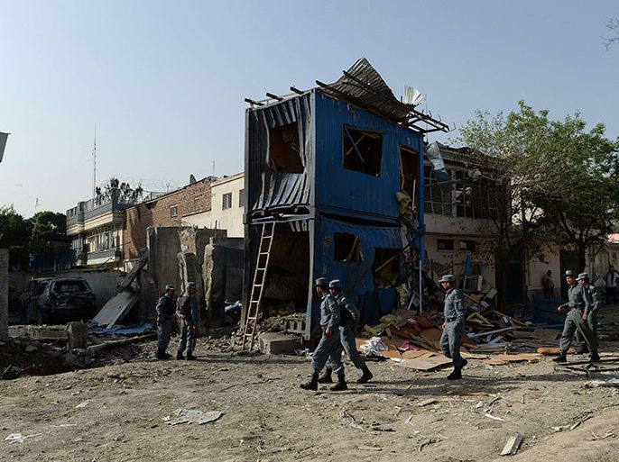 Afghan policemen arrive at the site of a suicide attack in Kabul on May 25, 2013. Explosions rocked central Kabul for several hours on May 24, after Taliban gunmen launched a major suicide and gun attack centred on a compound of the International Organization for Migration (IOM). One police officer was killed and five militants were shot dead as security forces hunted down the attackers, with prolonged bursts of gunfire and grenade blasts heard across the Afghan capital. AFP PHOTO/ SHAH Marai