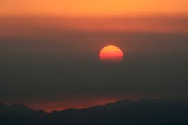 GLENDALE, CA - MAY 03: The sun sets behind smoke clouds from the Springs fire in Newbury Park and Camarillo on May 3, 2013 in Glendale, California. The fire has already spread to more than 28,000 acres and is only 20-30 percent contained. It's damaged dozens of structures and put some 4,000 people in harm's way. Kevork Djansezian/Getty Images/AFP== FOR NEWSPAPERS, INTERNET, TELCOS & TELEVISION USE ONLY ==
