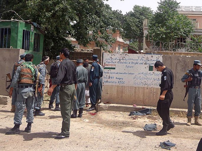 Pul-e Khumri, Baghlan, AFGHANISTAN : Afghan policemen stand at the site of a suicide bombing in front of the provincial council building in the city of Pul-e-Khumri, capital of northern Baghlan Province on May 20, 2013.