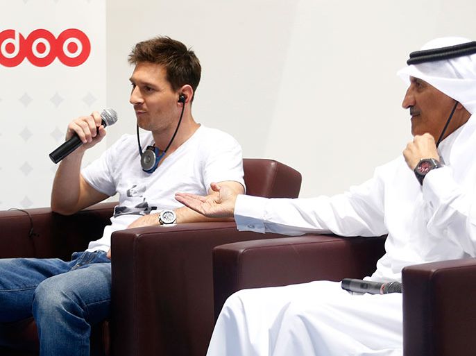 Argentina's Lionel Messi (L) talks next Ooredoo Chairman Sheikh Abdullah Bin Mohammed Bin Saud Al-Thani during a news conference at the Aspire Academy of Sports Excellence in Doha, May 20,2013. REUTERS/Fadi Al-Assaad (QATAR - Tags: SPORT SOCCER)