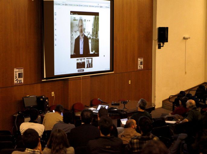 Universitary students participate in a teleconference with the founder of WikiLeaks, Julian Assange (screen) at the Aula Magna of the Psychology Faculty in Montevideo, Uruguay, 15 May 2013. The sovereignty of the countries of Latin America and the Caribbean is 'at risk' because USA 'controls and monitors almost all' of your communications through the Internet, said Assange from his asylum in the Embassy of Ecuador in London