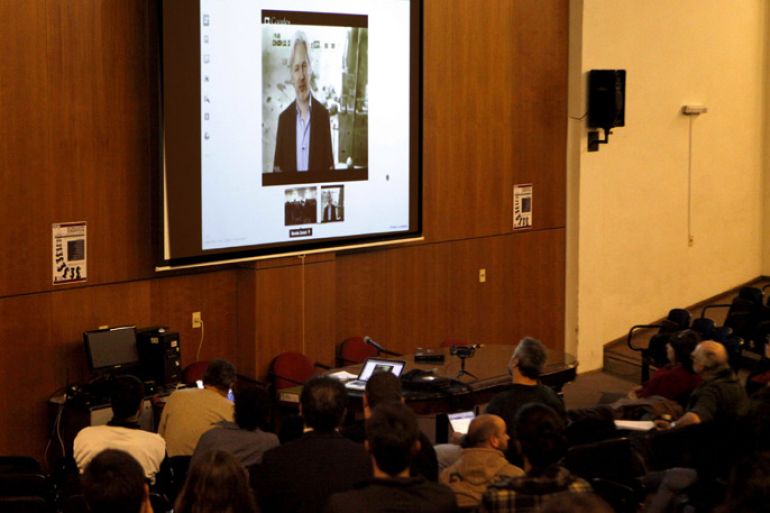 Universitary students participate in a teleconference with the founder of WikiLeaks, Julian Assange (screen) at the Aula Magna of the Psychology Faculty in Montevideo, Uruguay, 15 May 2013. The sovereignty of the countries of Latin America and the Caribbean is 'at risk' because USA 'controls and monitors almost all' of your communications through the Internet, said Assange from his asylum in the Embassy of Ecuador in London