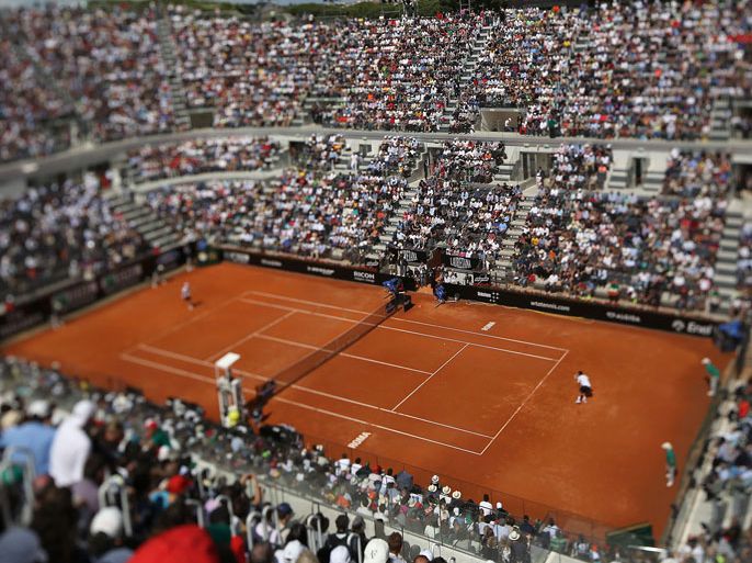 This picture taken with a tilt and shift lens shows Serbia's Novak Djokovic and Czech Republic's Tomas Berdych playing their quarter-finals match on May 17, 2013 at the Rome Masters. AFP PHOTO / TIZIANA FABI