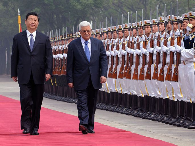 A photograph supplied by the Palestinian Authority on 06 May 2013 shows China's President Xi Jinping (L) accompanying his guest, Palestinian President Mahmoud Abbas (C), as they review a Chinese honor guard at Abbas arrival ceremony in Beijing, China, 06 May 2013. EPA/THAER GHANAIM/HANDOUT HANDOUT EDITORIAL USE ONLY