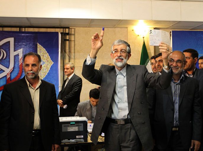 Tehran, -, IRAN : Iranian former parliament speaker, Gholam Ali Haddad Adel shows his Identification Document as he registers his candidacy for the upcoming presidential election at the interior ministry in Tehran on May 9, 2013. Iran began a five-day registration period for candidates in Iran's June