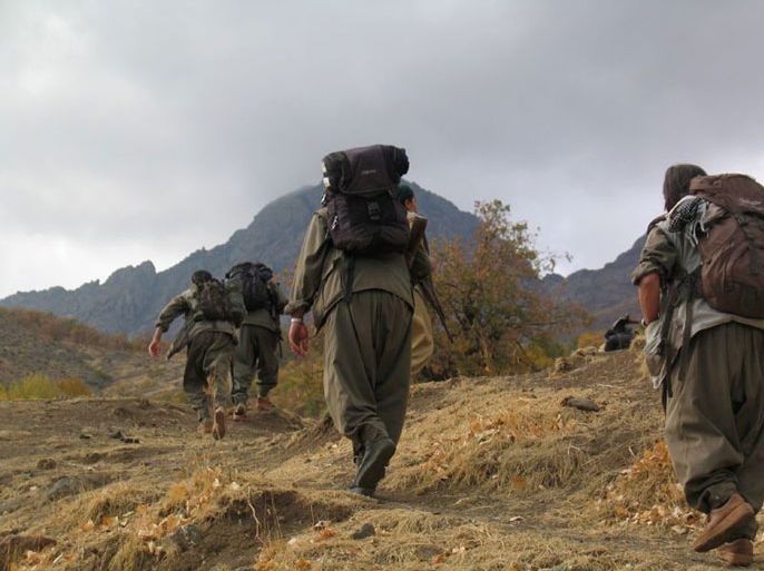 This handout photo released by the Firat New Agency shows fighters of the outlawed Kurdistan Workers' Party (PKK) walking in unknown mountains from Turkey through the border with Iraq on May 8, 2013. Kurdish rebel leaders have confirmed that their fighters will begin withdrawing from Turkey into bases in neighbouring Iraq on May 8 and warned Ankara against "provocations and clashes" which could hamper their retreat. There are an estimated 2,000 armed PKK militants inside Turkey and up to 5,000 in northern Iraq, which Kurdish rebels have used as a springboard for attacks targeting Turkish security forces in the southeast. AFP PHOTO/FIRAT NEWS AGENCY/STR