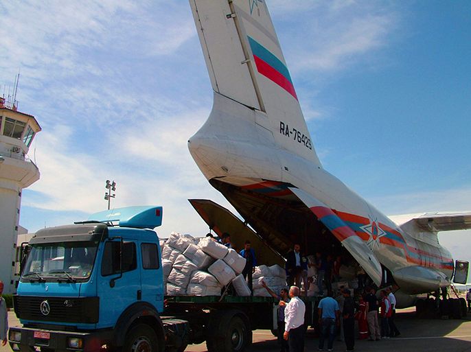 Workers are seen unloading humanitarian aid sent from Russia to the Syrian government in this handout photograph distributed by Syria's national news agency SANA on May 28,2013. Two planes loaded with 30 tons of humanitarian aid arrived to al-Bassel airport in lattakia city from Russia on Tuesday, SANA said. REUTERS/SANA (SYRIA - Tags: CONFLICT POLITICS TRANSPORT ) ATTENTION EDITORS - THIS IMAGE WAS PROVIDED BY A THIRD PARTY. FOR EDITORIAL USE ONLY. NOT FOR SALE FOR MARKETING OR ADVERTISING CAMPAIGNS. THIS PICTURE IS DISTRIBUTED EXACTLY AS RECEIVED BY REUTERS, AS A SERVICE TO CLIENTS