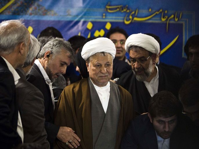 BEH091 - Tehran, -, IRAN : Former Iranian president Akbar Hashemi Rafsanjani (C) arrives to register his candidacy for the upcoming presidential election at the interior ministry in Tehran on May 11, 2013. Rafsanjani, who has been isolated since the 2009 presidential election which saw massive street protests against the disputed re-election of President Mahmoud Ahmadinejad, registered his candidacy to stand for office again. AFP PHOTO/BEHROUZ MEHRI