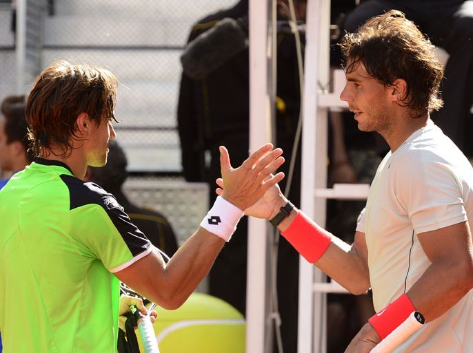 Spanish player Rafael Nadal (R) shakes hands with Spanish player David Ferrer at the end of their tennis match at the Madrid Masters at the Caja Magica (Magic Box) sports complex in Madrid on May 10, 2013. Nadal won 4-6, 7-6 (7/3), 6-0. AFP PHOTO/ JAVIER SORIANO