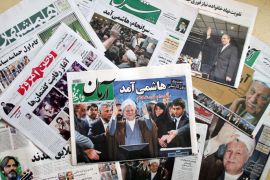 AK002 - Tehran, -, IRAN : A selection of daily Iranian newspapers mainly fronted by an image of Iran's former president Akbar Hashemi Rafsanjani, are seen on May 12, 2013, in Tehran. Rafsanjani who registered for next month's presidential election, is disliked among regime hardliners for criticising the crackdown that followed Mahmoud Ahmadinejad's disputed re-election in 2009. AFP PHOTO/ATTA KENARE