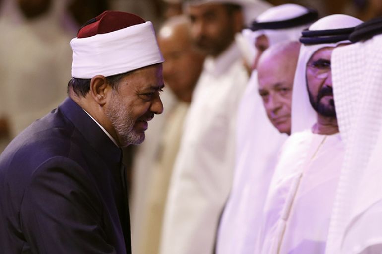 The Grand Imam of Al-Azhar Sheikh Ahmed al-Tayeb shakes hands with attendees of the opening session of the annual Arab Media Forum in Dubai on May 14, 2013 where discussions revolved around the changes and developments in Arab media. AFP PHOTO/KARIM SAHIB