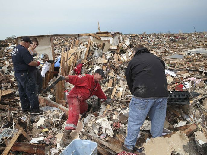 Moore, Oklahoma, UNITED STATES : MOORE, OK - MAY 21: Residents search through rubble after a powerful tornado ripped through the area on May 21, 2013 in Moore, Oklahoma. The town reported a tornado of at least EF4 strength and two miles wide that touched down yesterday killing at least 24 people and leveling everything in its path. U.S. President Barack Obama promised federal aid to supplement state and local recovery efforts. Scott Olson/Getty Images/AFP== FOR NEWSPAPERS, INTERNET, TELCOS & TELEVISION USE ONLY ==