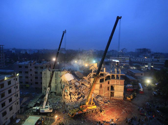 In this photograph taken on April 29, 2013, cranes operated by Bangladeshi Army personnel are pictured at the scene following the April 24 collapse of an eight-storey building in Savar, on the outskirts of Dhaka. The death toll from last week's collapse of a garment factory complex in Bangladesh passed 500 on May 3, 2013 after dozens more bodies were pulled out from the wreckage overnight, the army said.