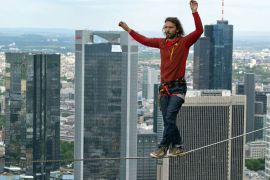 The professional slackliner Reinhard Kleindl from Austria walks on a 185 m high rope between two towers of the 'Tower 185' during the skyscraper festival in Frankfurt/Main, Germany, 25 May 2013. Several hundred thousand visitors are expected to come to the two-day spectacle. Highlights are spectacular performances in the air and numerous concerts. EPA
