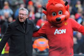 (FILES) In this file picture taken on April 8 2012 Manchester United manager Alex Ferguson (L) greets mascot Fred the Red before the English Premier League football match between Manchester United and Queens Park Rangers at Old Trafford in Manchester, north-west England. Alex Ferguson is to retire as the manager of Manchester United, the English Premier League champions announced on May 8, 2013. Ferguson, 71, has been in charge at Old Trafford for 26 years, guiding United to 13 Premier League titles and two Champions League crowns.