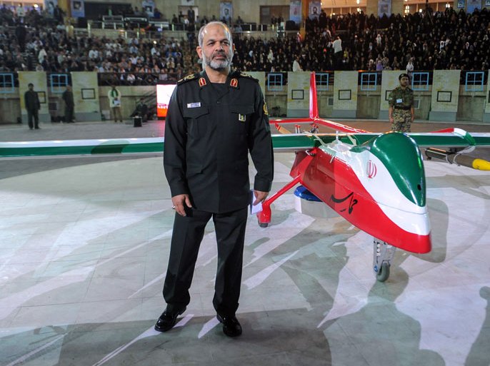 IRAN : A picture released by Iranian news agency ISNA shows Iranian Defence Minister Ahmad Vahidi standing next to the new Iranian made drone "Epic" during a ceremony in Tehran on May 9, 2013. Iran unveiled the new drone called "Epic" capable of carrying out both surveillance and attack missions the Mehr news agency reported.