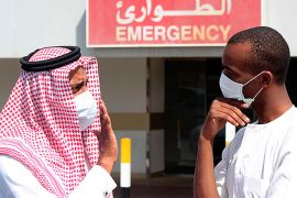 Men wearing surgical masks as a precautionary measure against the novel coronavirus, speak at a hospital in Khobar city in Dammam May 23, 2013. Saudi Arabia has announced another death from the SARS-like novel coronavirus (nCoV) in its central al-Qassim region, bringing the total number of deaths in the kingdom to 17. REUTERS/Stringer (SAUDI ARABIA - Tags: HEALTH SOCIETY)