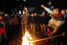 Sofia, -, BULGARIA : Protestors hold torches and shout slogans during a protest in front of the National Palace of Culture in Sofia on May 12, 2013. Bulgarian ousted premier Boyko Borisov's party came first in tense elections today but fell short of a majority, exit polls showed, setting the scene for political stalemate