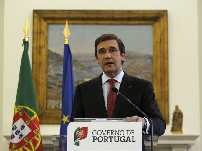 FL401 - Lisbon, -, PORTUGAL : Portuguese Prime Minister Pedro Passos Coelho addresses the nation from his official residence at Sao Bento palace in Lisbon on May 3, 2013. Passos Coelho said today that the government aimed to slash 30,000 public sector jobs as part of a sweeping package of spending cuts to satisfy international creditors. In a speech to the nation, Pedro Passos Coelho also said that the full pension age would be pushed back to 66 years old and civil servants would be expected to work 40 hours per week instead of 35. AFP PHOTO/ HENRIQUES DA CUNHA