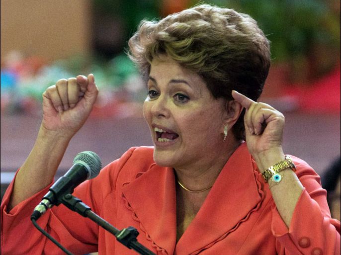 Brazilian President Dilma Rousseff delivers a speech during a Christmas celebration ceremony for scavengers and homeless people, in Sao Paulo, Brazil, on December 21, 2012. Rousseff slammed all forms of violence against the homeless in Brazil during an address at a Christmas event with garbage collectors in Sao Paulo. AFP PHOTO/YASUYOSHI CHIBA