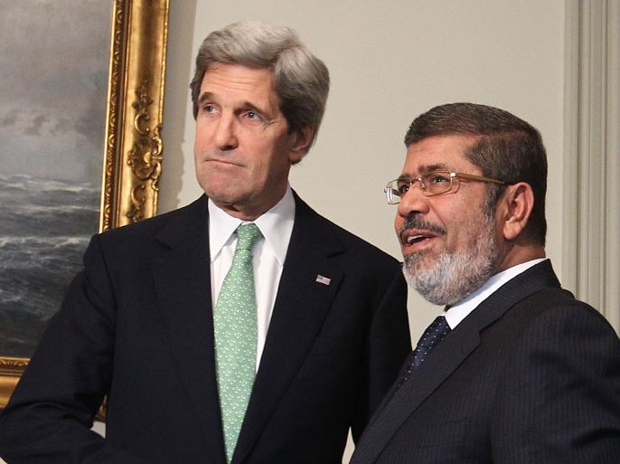 Egyptian President Mohamed Morsi (R) and US Secretary of State John Kerry, shake hands before a meeting at the Presidential Palace, in Cairo, Egypt, 03 March 2013. Kerry's two-day visit comes as part of the Middle East leg of his first trip abroad and as Egypt sees a widening rift between its Islamist president Mohamed Morsi and the mostly secular opposition. EPA/KHALED ELFIQI