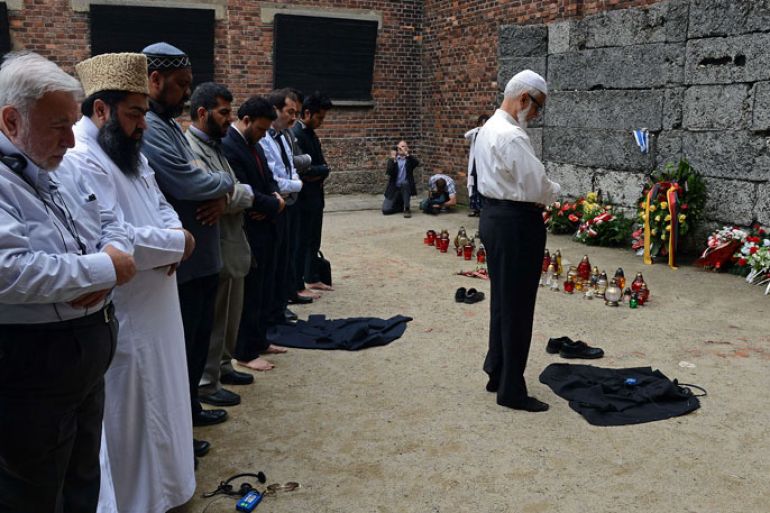 Muslim religious leaders from across the globe pray in front of so-called death wall at the Nazi death camp Auschwitz-Birkenau as part of an anti-genocide programme on May 22, 2013. Muslim religious leaders from across the globe met with Holocaust survivors in an emotional encounter at Warsaw's synagogue, as part of an anti-genocide programme that includes a visit to Auschwitz