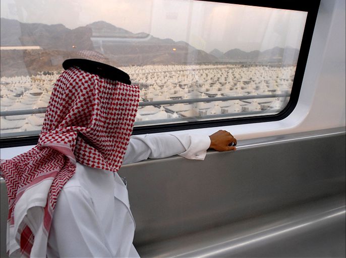 epa02375981 A Saudi man looks at the tent city of as he sits onboard the new fast commuter train Mashair (Mecca Metro) on its first run test in Mecca, Saudi Arabia, 05 October 2010. The Mashair fast commuter train which has started om 05 October a 30 days test run period, is capable of reaching speeds up to 300 km per hour. It runs from Mecca to Medina through Jeddah's King Abdul Aziz International airport and connects the Haj holy sites making it easier for the some three million Muslim Haj pilgrims, to reach all the sites instead of using buses and private vehicles. EPA/STR