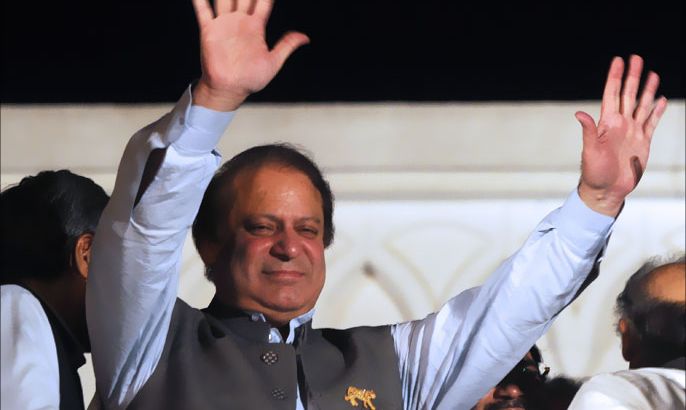 Former Pakistani prime minister and head of the Pakistan Muslim League-N (PML-N) Nawaz Sharif waves to supporters after his party victory in general election in Lahore on May 11, 2013. Sharif declared victory for his centre-right party in Pakistan's landmark elections on May 11, as unofficial partial results put him on course to win a historic third term as premier. The result represented a remarkable comeback for a man who was deposed as premier in a 1999 military coup and came after millions of people defied polling day attacks that left 24 dead to participate in the high-turnout vote. AFP PHOTO / ARIF ALI