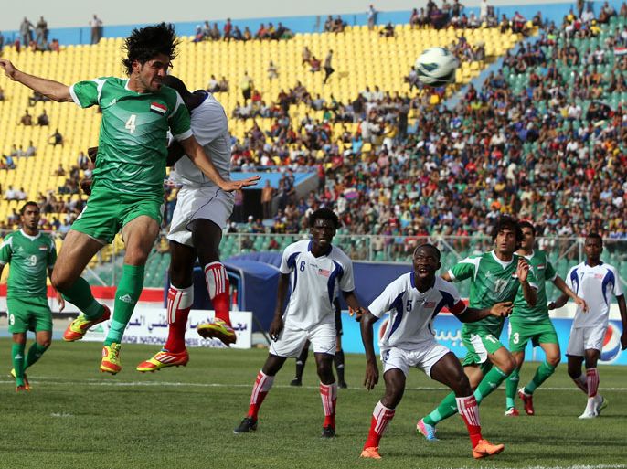 AHR23 - Baghdad, -, IRAQ : Khldou Ebrahim of Liberia vies for the ball against Khaldoun Ibrahim of Iraq (L) during their friendly match at al-Shaab Stadium in Baghdad on May 27, 2013. Two of the blasts which killed 58 people in the Baghdad area and northern Iraq, went off near the the al-Shaab stadium as Iraq's national football team were playing Liberia the friendly. AFP PHOTO/AHMAD AL-RUBAYE