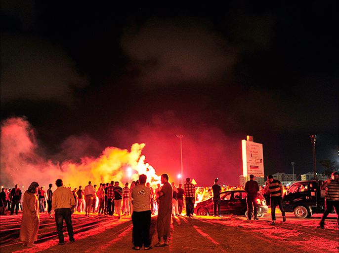 Protesters block the road and set off fireworks, after they burned two vehicles belonging to the Libyan Army's First Infantry Brigade in Benghazi June 14, 2013. The protesters said they had burnt the vehicles, both of which belonged to the Libyan Army's First Infantry Brigade, as they accused the brigade of being responsible for clashes that broke out at the headquarters of the Libya Shield militia last week. No people were injured during the fires, according to the demonstrators. REUTERS/Esam Al-Fetori (LIBYA - Tags: POLITICS MILITARY CIVIL UNREST)