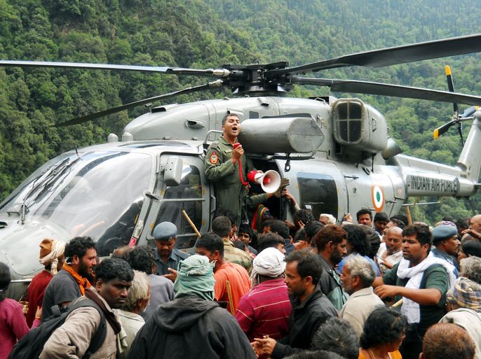 Indian pilgrims wait to board a helicopter to be evacuated after they were stranded because of heavy flooding from near Kedarnath in the state of Uttarakhand on June 24, 2013. Indian priests are planning to cremate hundreds of flood victims on June 24, as heavy rains halted the search for thousands of tourists stranded in the devastated Himalayan region, officials said