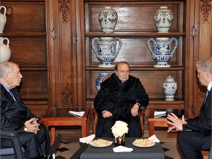 A photo obtained from Algerian Press Service (APS) news agency shows Algeria's President Abdelaziz Bouteflika (C) receiving Algerian Chief of Staff Ahmed Gaid Salah (L) and Algeria's Prime Minister Abdelmalek Sellal (R) in the Paris hospital on June 12, 2013 in one of the first pictures to emerge since he was hospitalised in France in April after a mini-stroke. Pictures of Bouteflika were published by APS to dispel rumours circulating in both Algiers and Paris about the 76-year-old president's condition deteriorating. AFP PHOTO / APS / STR