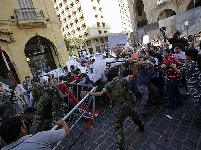 TOPSHOTSLebanese left-wing demonstrators clash with riot police outside the parliament in the capital Beirut on June 20, 2013, during a demonstration against the extension of the mandate of the Lebanese parliament. Earlier in the month the Lebanese parliament extended its mandate by 17 months to November 2014, after failing to adopt a new electoral law at a time of deep divisions over the war in neighbouring Syria. AFP PHOTO / JOSEPH EID