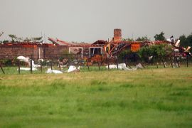 A home, damaged by a tornado, is seen south along Interstate-40 eastbound just east of El Reno, Oklahoma May 31, 2013. Violent thunderstorms spawned tornadoes that menaced Oklahoma City and its already hard-hit suburb of Moore on Friday, killing a mother and her baby, and officials worried that drivers stuck on freeways could be trapped in the path of dangerous twisters. One twister touched down on Interstate 40 and was headed toward Oklahoma City. REUTERS/Bill Waugh (UNITED STATES - Tags: DISASTER ENVIRONMENT)