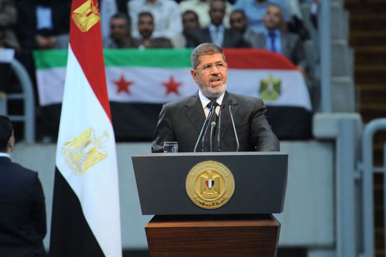 Cairo, -, EGYPT : In this hand out picture released by the Egyptian Presidency Egyptian President Mohammed Morsi gives his speech to thousands of islamists and Syrian opposition supporters during the "support for Syria" rally at Cairo stadium on June 15, 2013 in Cairo, Egypt. Egypt's Islamist President Mohammed Morsi on Saturday announced the "definitive" severing of relations with war-torn Syria, which is suffering from more than two years of civil war. Egypt "decided today to definitively break off relations with the current regime in Syria, to close that regime's embassy in Cairo and to recall Egypt's charge d'affaires" from Damascus, Morsi told thousands of Islamist supporters in a Cairo stadium for a "Support for Syria" rally.