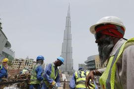 Labourers work near the Burj Khalifa, the tallest tower in the world, in Dubai in this May 9, 2013 file photo. Gulf nations have relied heavily on the supply of cheap labour from Asia to build their vast housing and infrastructure needs. To match story EMIRATES-LABOUR/ REUTERS/Ahmed Jadallah/Files (UNITED ARAB EMIRATES - Tags: BUSINESS CONSTRUCTION EMPLOYMENT)