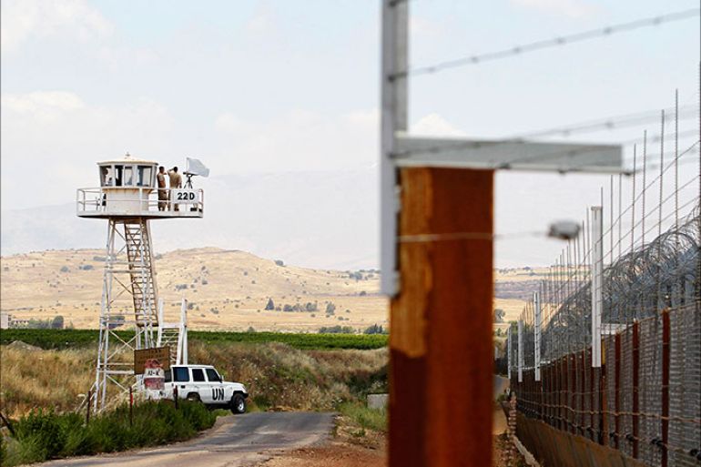 United Nations (U.N.) peacekeeping soldiers from Austria stand on an observation tower near the Quneitra border crossing between Israel and Syria, in the Israeli-occupied Golan Heights June 10, 2013. Syrian President Bashar al-Assad, backed by Iran and Lebanon's Hezbollah, may prevail in the more than two-year-old uprising against him, Israel's intelligence minister said on Monday. REUTERS/Baz Ratner (POLITICS)