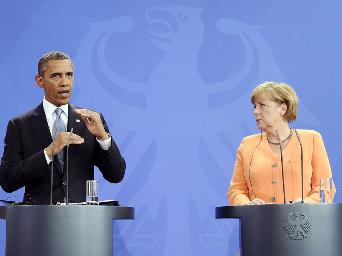 US President Barack Obama answers a question during a joint press conference with German Chancellor Angela Merkel following their bilateral meeting at the Chancellery in Berlin, Germany, on June 19, 2013. Obama arrived for his first visit as US president to Berlin on Tuesday for talks with German Chancellor Angela Merkel and a major open-air speech at the city's Brandenburg Gate. The 24-hour visit comes nearly 50 years to the day after John F. Kennedy's "Ich bin ein Berliner" solidarity pledge to the embattled western sectors of the city