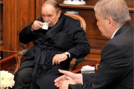 A photo obtained from Algerian Press Service (APS) news agency shows Algeria's President Abdelaziz Bouteflika (C) drinking tea as he receives Algeria's Prime Minister Abdelmalek Sellal (R) and Chief of Staff Ahmed Gaid Salah (unseen) in a Paris hospital on June 12, 2013 in one of the first pictures to emerge since he was hospitalised in France in April after a mini-stroke. Pictures of Bouteflika were published by the APS to dispel rumours circulating in both Algiers and Paris about the 76-year-old president's condition deteriorating. AFP PHOTO / APS / STR