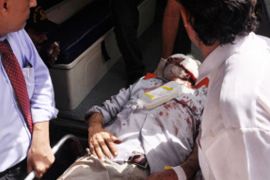 PAKISTAN : Pakistani paramedics shift Maqbool Baqir, a senior judge, into an ambulance after he was injured in a bomb attack in Karachi on June 26, 2013.