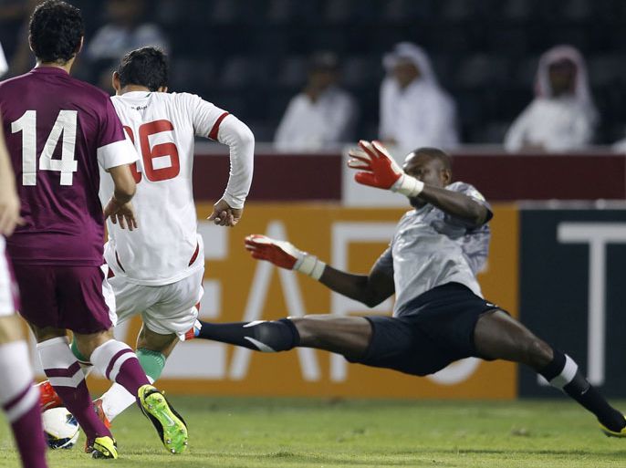 Iran's Reza Ghoochannejhad (16) scores a goal against Qatar's goalkeeper Qassim Burhan during their Asian qualifying soccer match for the 2014 World Cup, in Doha June 4, 2013. REUTERS/Fadi Al-Assaad (QATAR - Tags: SPORT SOCCER)