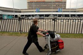 Moscow, -, RUSSIAN FEDERATION : A man walks in front of Sheremetyevo airport terminal F in Moscow on June 26, 2013 where US intelligence leaker Edward Snowden on June 26, 2013 spent a fourth day with his onward travel plans still a mystery as Ecuador warned it could take months
