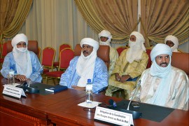 This photo taken on June 7, 2013 shows Taureg leaders waiting for a meeting to start on the Malian crisis in Ouagadougou. Talks between Malian authorities and armed ethnic Tuareg groups, who hold the northeastern town of Kidal, will get underway on June 8 after a day's delay, a source close to the Burkinabe mediators said. AFP PHOTO / AHMED OUOBA