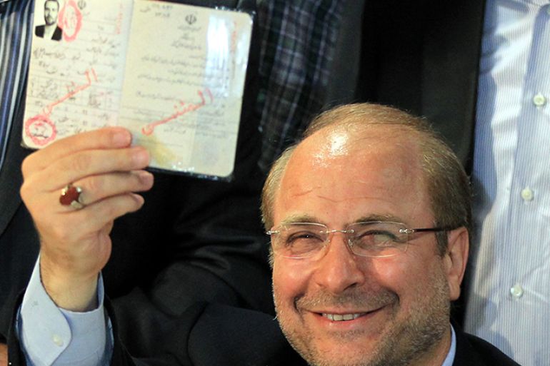 epa03695646 Iranian Mayor Mohammad Baqer Qalibaf shows his Id to media at the at the Interior ministry as he registers his candidacy during the registration for Iran's upcoming presidential election in June 14 in Tehran, Iran, 11 May 2013. Registration for candidates started on 07 May at the Ministry of Interior and will continue for five days. According to the Iranian constitution, current President Mahmoud Ahmadinejad cannot run for a third term. The main race will be between conservative, reformist, and pro Ahmadinejad camps. EPA/ABEDIN TAHERKENAREH
