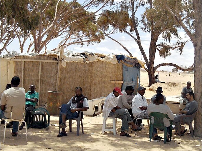 African refugees sit in their camp on June 30, 2013, in Chousha, southtern of Tunisia. Several hundred people who had fled the 2011 Libya conflict refused to leave the Choucha refugee camp which was due to be shut, blocking attempts to dismantle their tents, an AFP journalist reported. AFP PHOTO / MAATOUG
