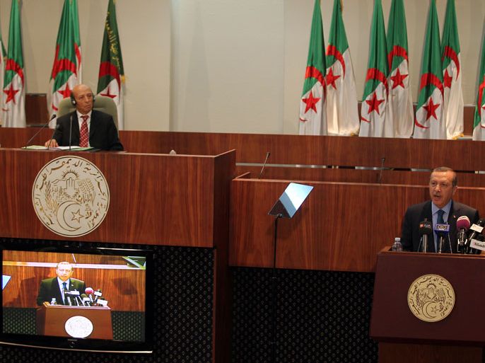 epa03731097 Turkish Prime Minister Recep Tayyip Erdogan (R) speaks in Algerian National Assembly in Algiers, Algeria, 04 June 2013. Erdogan arrived in Algeria, the second leg of his five-day visit to North African countries. EPA/MOHAMED MESSARA