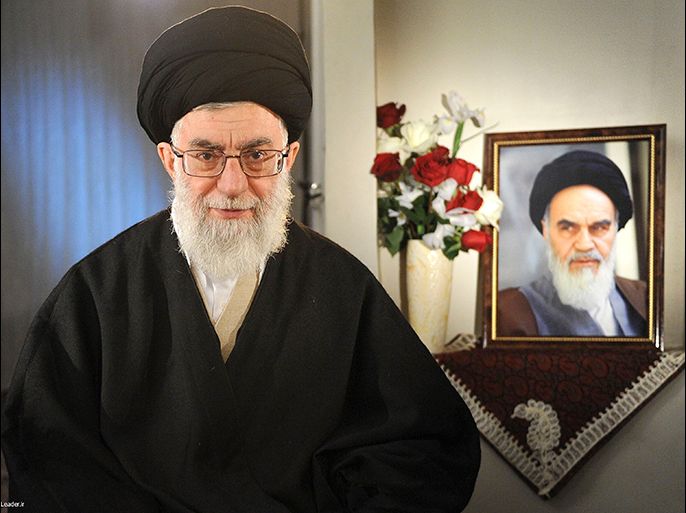 Iran's Supreme Leader Ayatollah Ali Khamenei sits next to a portrait of late leader Ayatollah Ruhollah Khomeini while taking part in a television live programme in Tehran on the occasion of the Iranian New Year in this March 21, 2011 file picture.