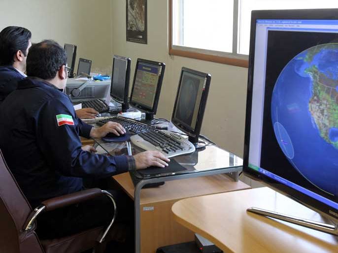 epa03126634 Iranian scientists receiving data from Navid Satellite at the Iranian space agency, in Mahdasht a suburb of city of Karaj, Iran, 29 February 2012. The Navid Satellite was reportedly launched into orbit 03 February 2012. Reports state that space agency officials said the site has no links to the military, and is only used to control satellites and to carry out scientific research. EPA/ABEDIN TAHERKENAREH