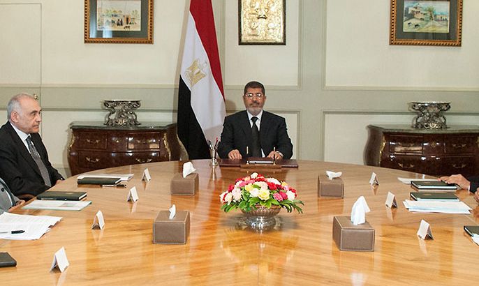 A handout picture released by the Egyptian presidency shows Egyptian President Mohamed Morsi (C) meeting with Foreign Minister Mohammed Kamel Amr (4th-L), Minister of Irrigation and Water Resources Water Mohammed Bahaa al-Din Saed (3rd-L) and other officials at the presidential palace in Cairo on June 2, 2013 to discuss the country's water crisis and Ethiopia's dam project on the Blue Nile. Ethiopia has begun diverting the Blue Nile as part of a giant dam project, officials said this week, risking potential unease from downstream nations Sudan and Egypt. AFP PHOTO / HO / EGYPTIAN PRESIDENCY
